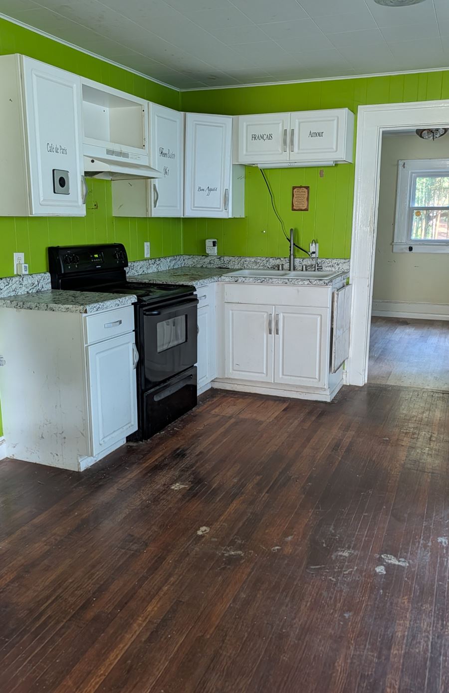 After: the same kitchen emptied down to the counters and floor